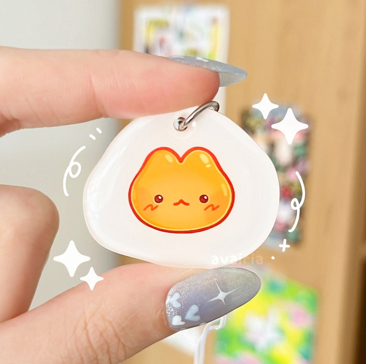 A small acrylic charm of an egg themed cat.